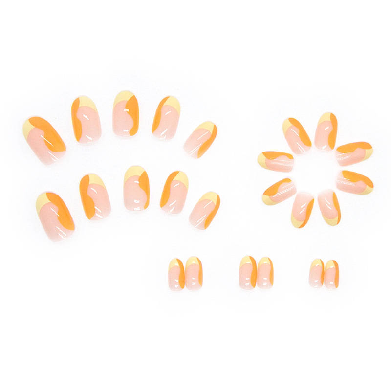 yellow french tip short round press on nail with ombre semi transparent base meshing into orange.