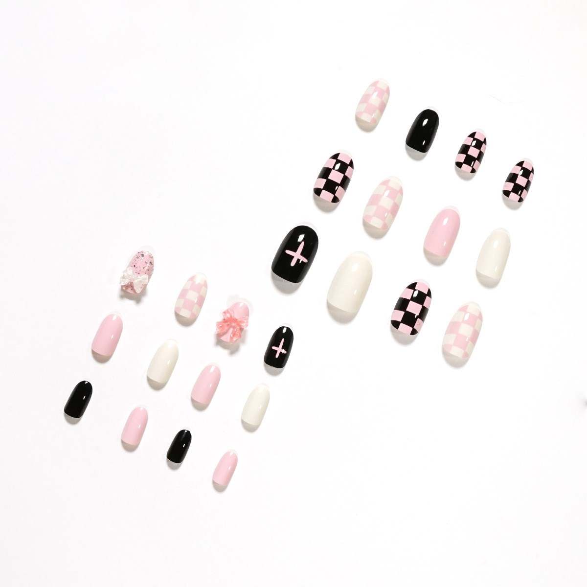 short round long lasting press on nails, pink black and white with checkered, plain, and cross designs and bow charms.